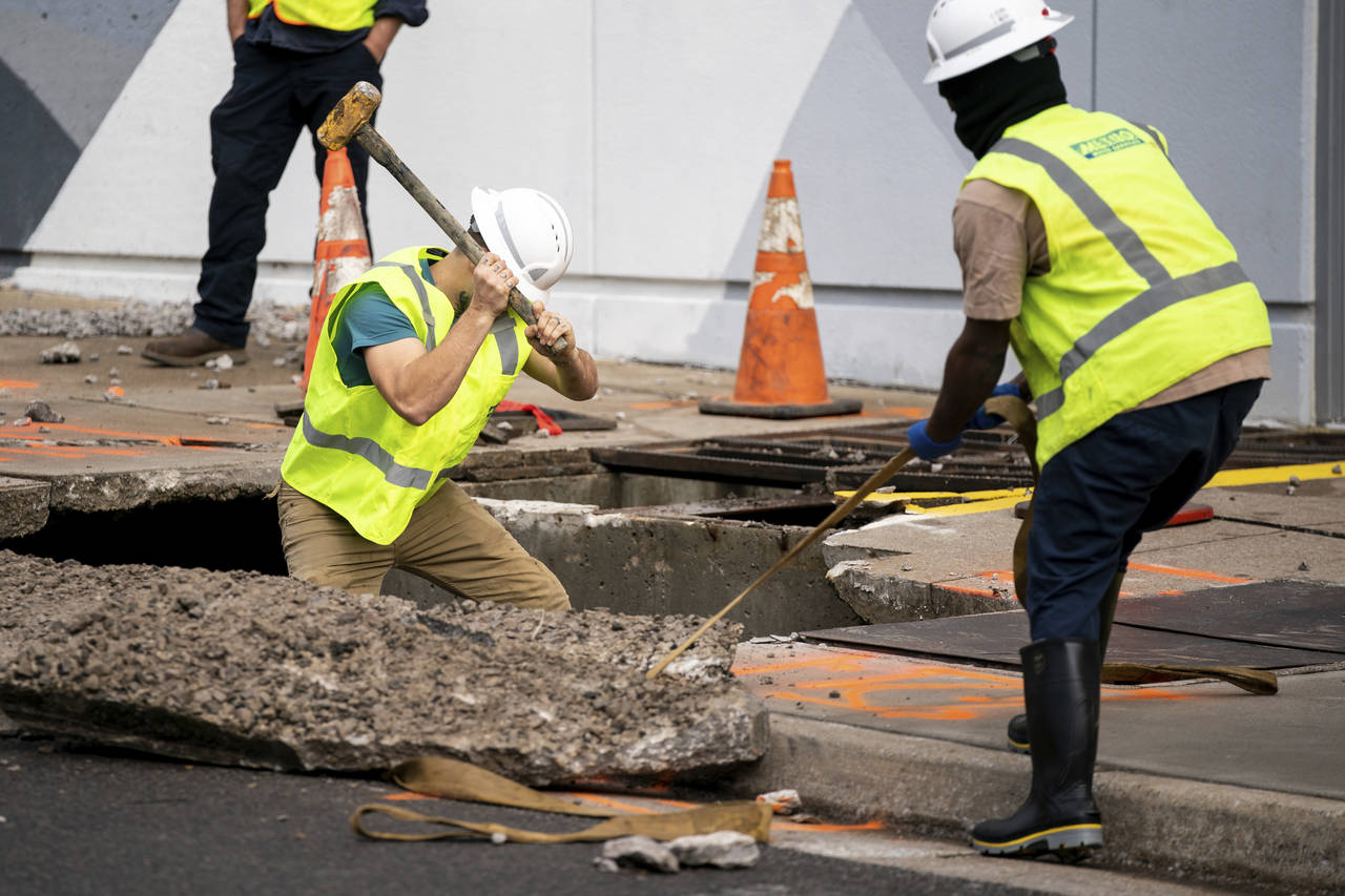 Crews work on 6th Ave. S. after a water main break flooded Bridgestone Arena in Nashville, Tenn., F...