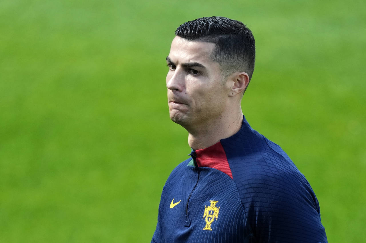Cristiano Ronaldo walks on the pitch during a Portugal soccer team training in Oeiras, outside Lisb...