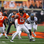 Anderson's 2 long TD runs help W. Virginia top Oklahoma St.
