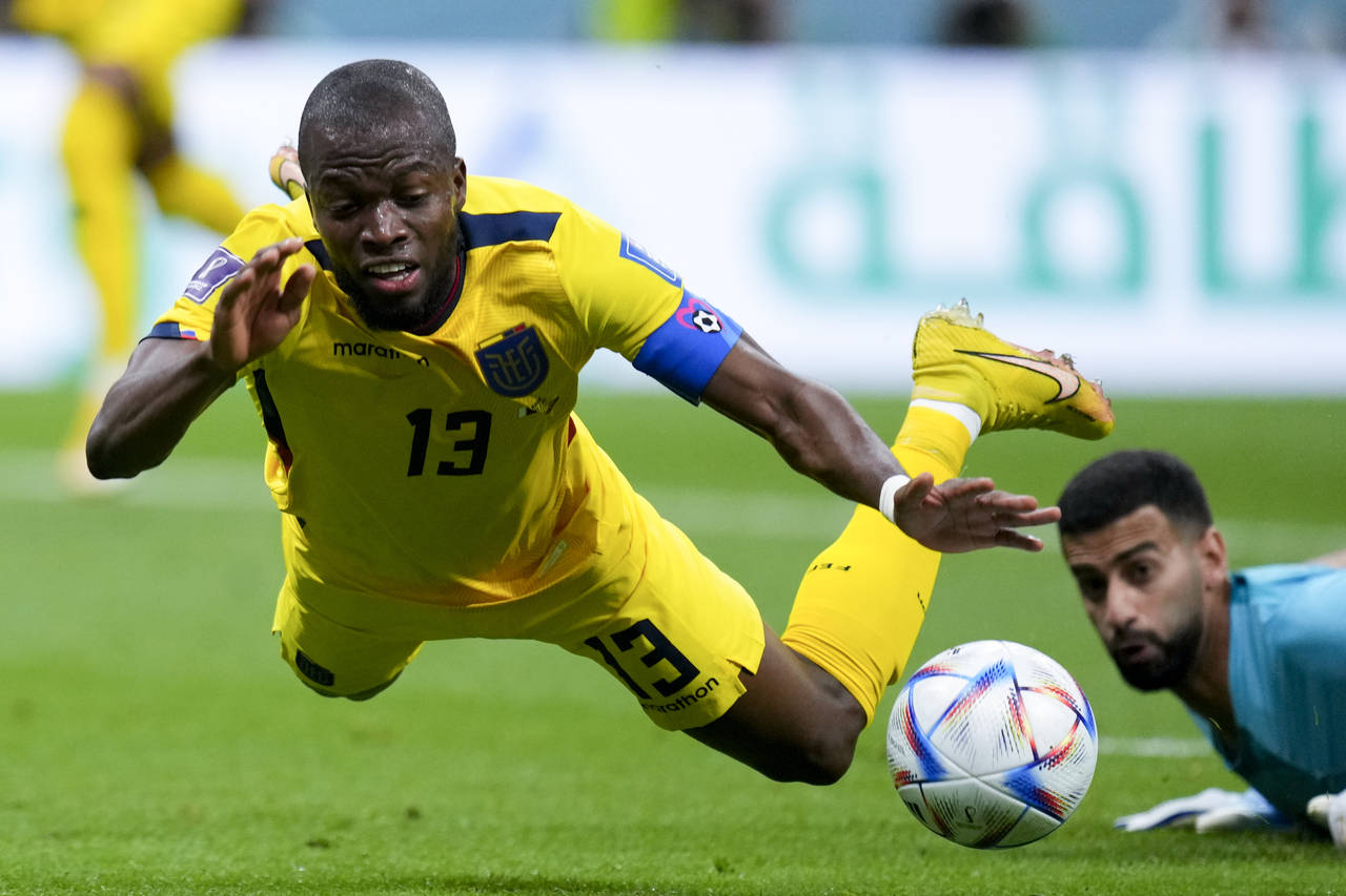 Ecuador's Enner Valencia falls, fouled by Qatar's goalkeeper Saad Al Sheeb, during a World Cup grou...
