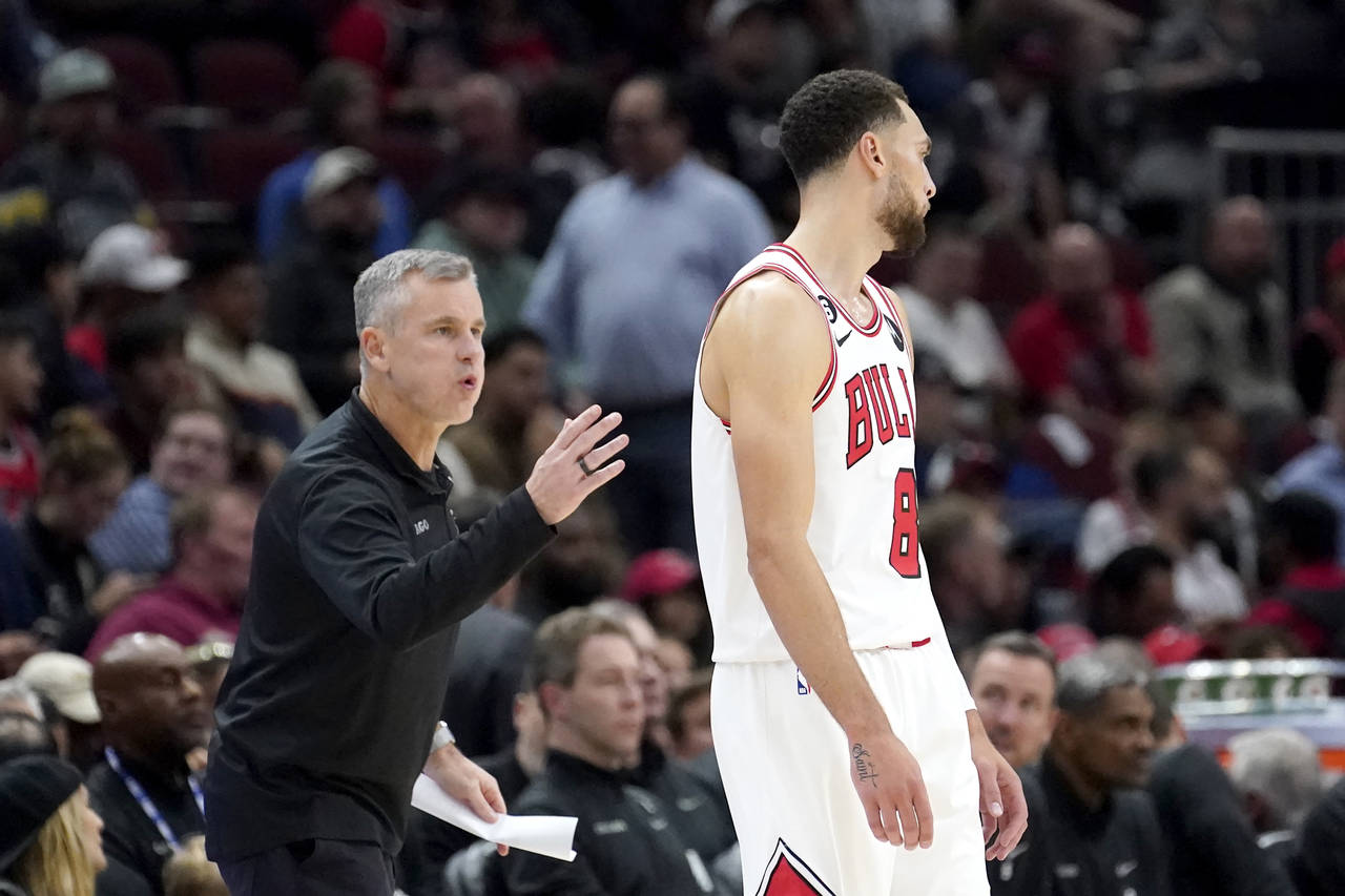 Chicago Bulls head coach Billy Donovan talks to Zach LaVine during the first half of an NBA basketb...