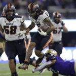 
              Oregon State running back Damien Martinez (6) leaps from the attempted tackle of Washington linebacker Cam Bright (2) during the first half of an NCAA college football game Friday, Nov. 4, 2022, in Seattle. (AP Photo/John Froschauer)
            