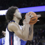 
              Gonzaga forward Anton Watson, front, drives to the basket while defended by Kentucky guard CJ Fredrick during the first half of an NCAA college basketball game, Sunday, Nov. 20, 2022, in Spokane, Wash. (AP Photo/Young Kwak)
            