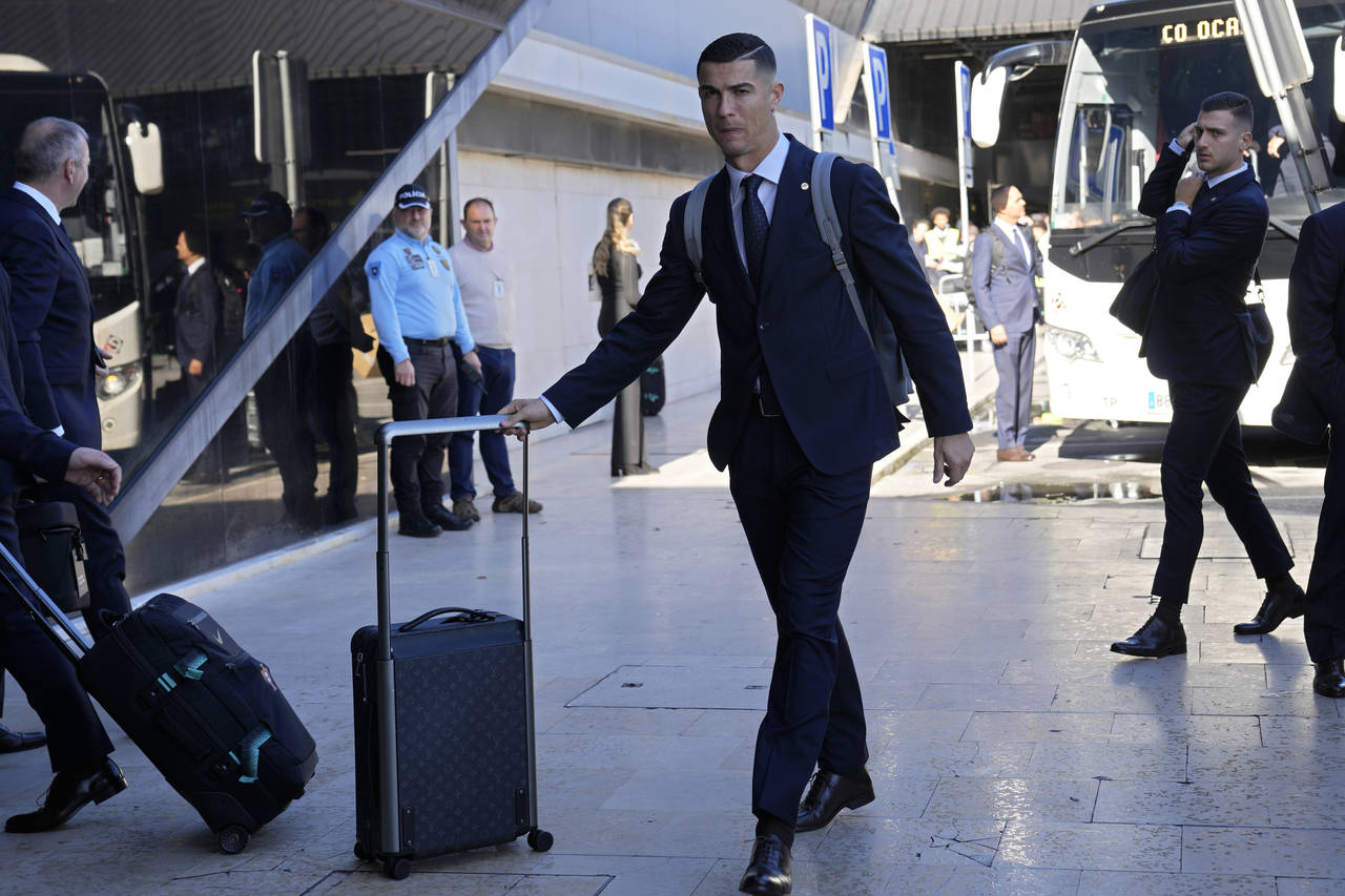 Portugal's Cristiano Ronaldo arrives with the Portuguese team at Lisbon airport to depart for the W...