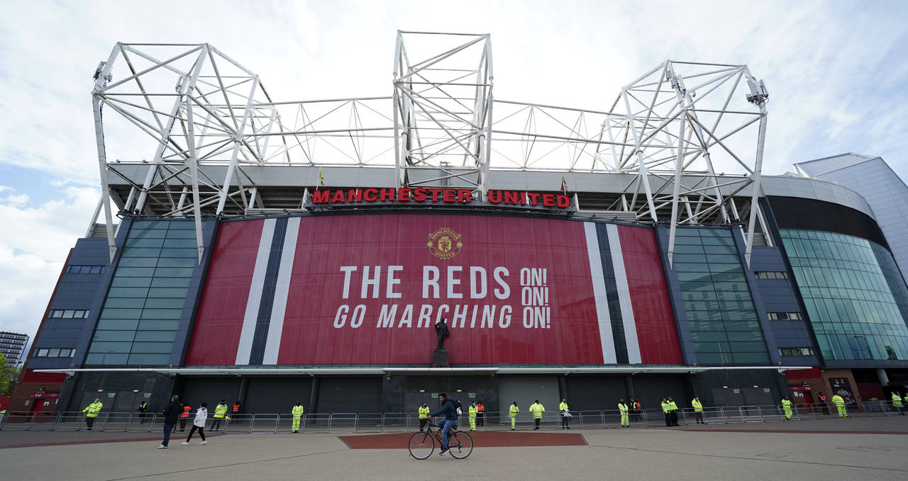 FILE - Security and stewards stand outside the Old Trafford stadium in Manchester, England, Tuesday...