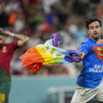 Spectator with rainbow flag runs onto field at World Cup