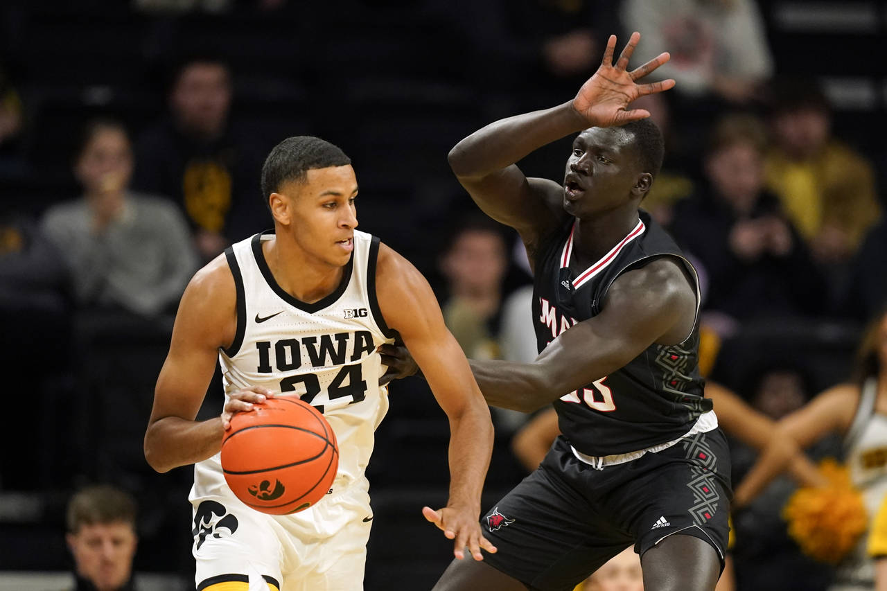 Iowa forward Kris Murray (24) drives around Omaha forward Akol Arop (33) during the first half of a...