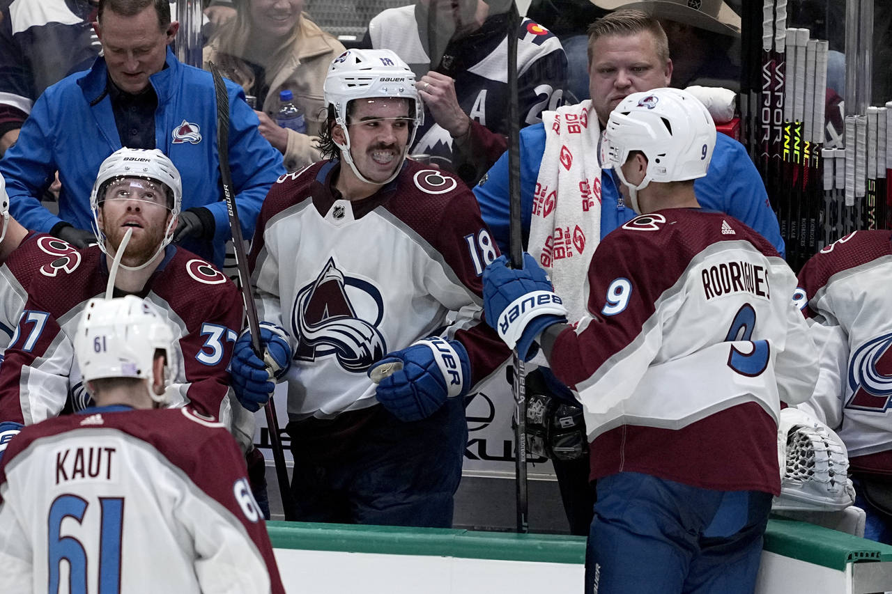 Alex Newhook (18) and Evan Rodrigues (9) celebrate after Rodrigues scored in the third period of an...