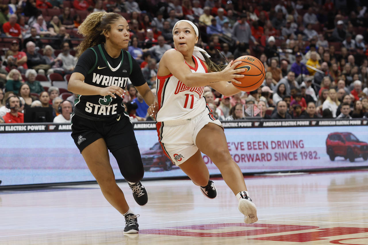 Ohio State's Kaia Henderson, right drives the lane against Wright State's Makiya Miller during the ...