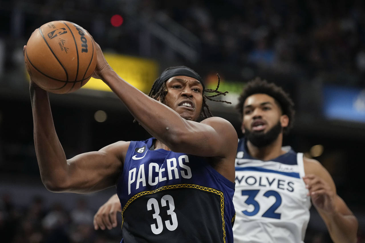 Indiana Pacers center Myles Turner (33) pulls in a rebound in front of Minnesota Timberwolves cente...