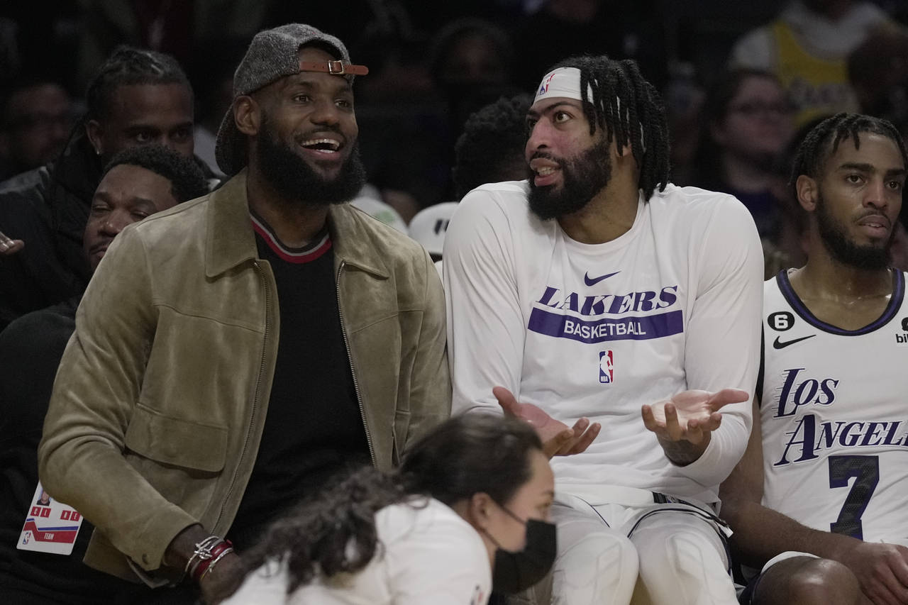 Los Angeles Lakers forward LeBron James, left, and forward Anthony Davis sit on the bench during th...