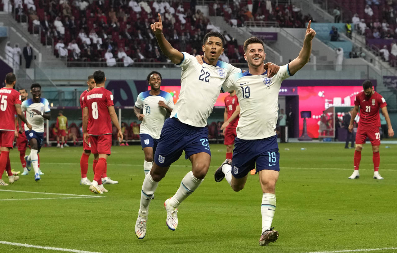 England's Jude Bellingham, centre, celebrates with England's Mason Mount after scoring his side's o...