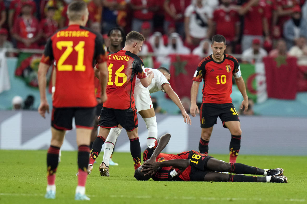 Belgium's Amadou Onana falls during the World Cup group F soccer match between Belgium and Morocco,...