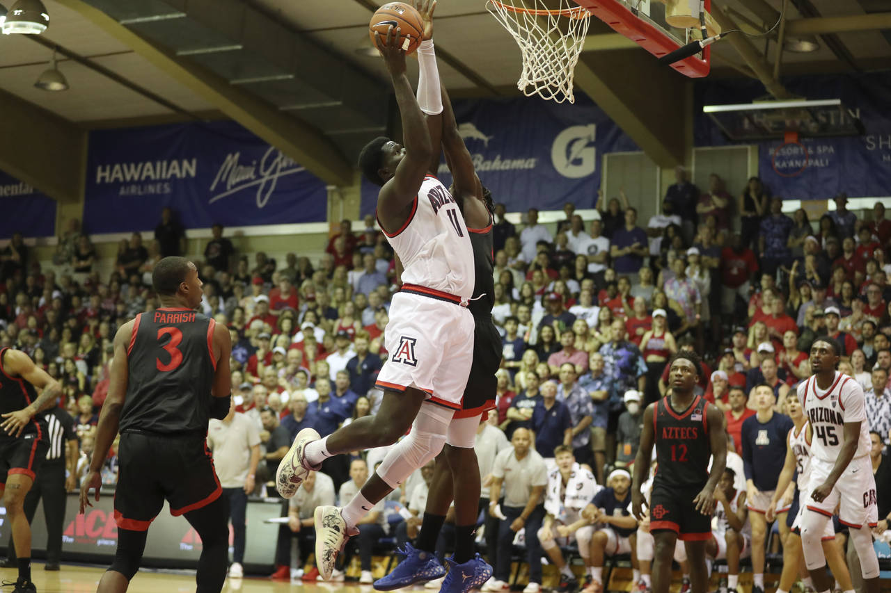 San Diego State forward Nathan Mensah fouls Arizona center Oumar Ballo as he makes a basket during ...