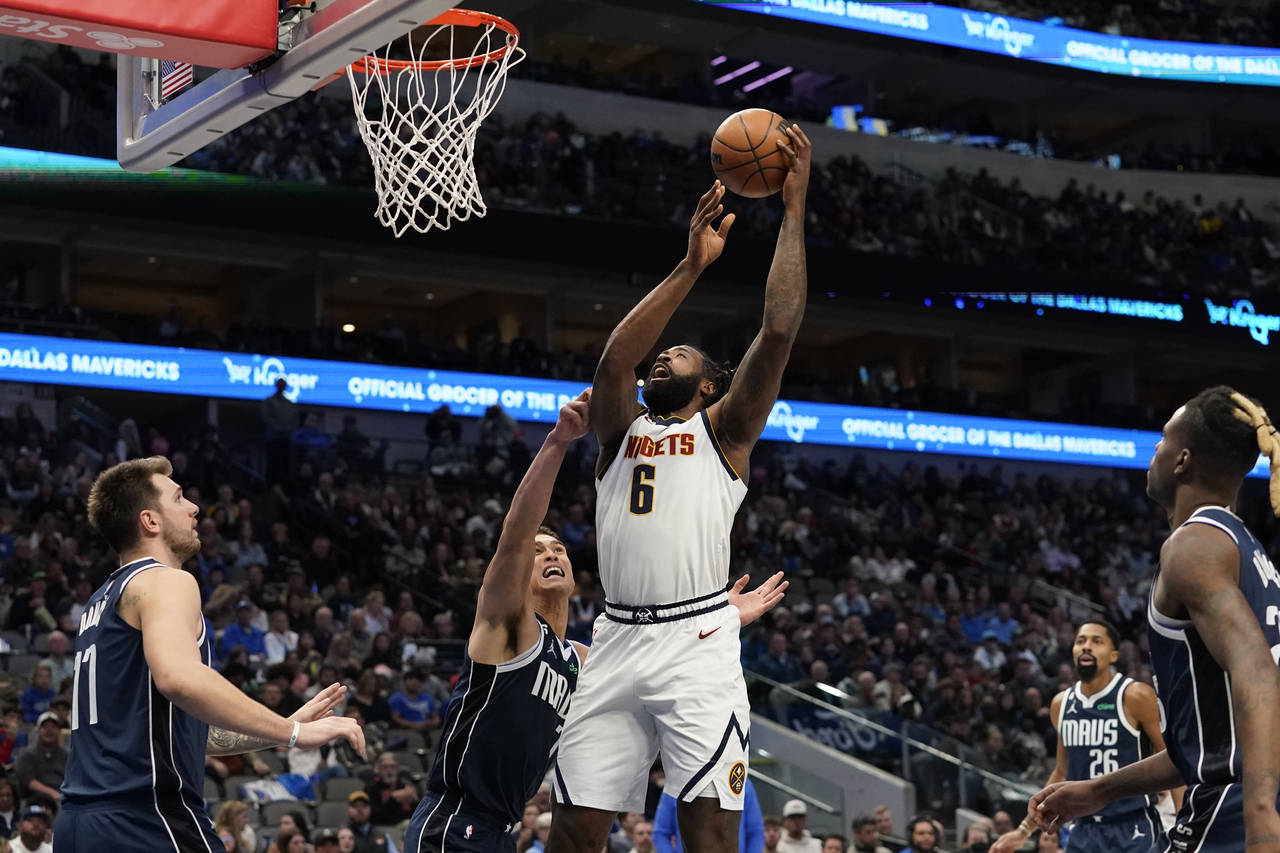 Denver Nuggets center DeAndre Jordan (6) shoots against Dallas Mavericks center Dwight Powell (7) a...