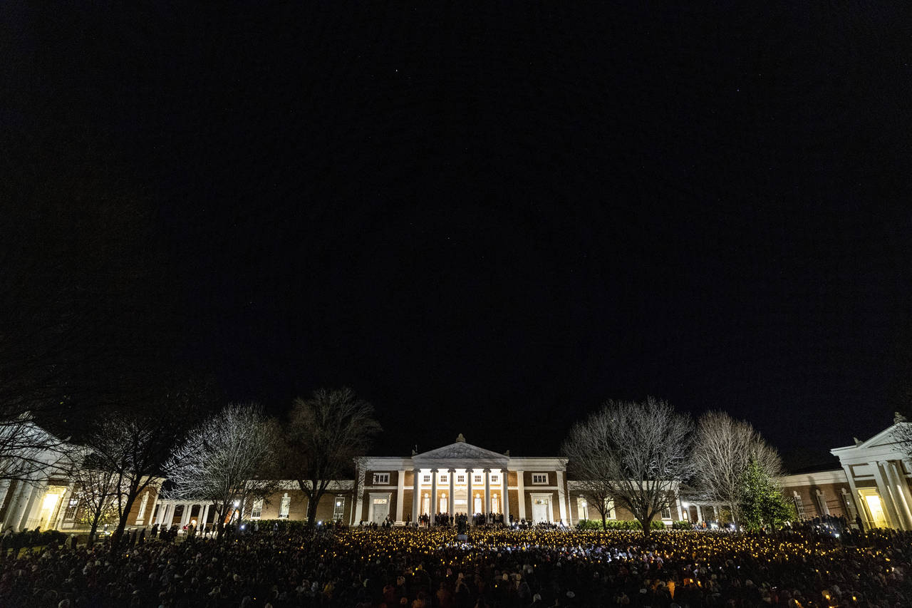 Students participate in a vigil in response to shootings that happened on the University of Virgini...