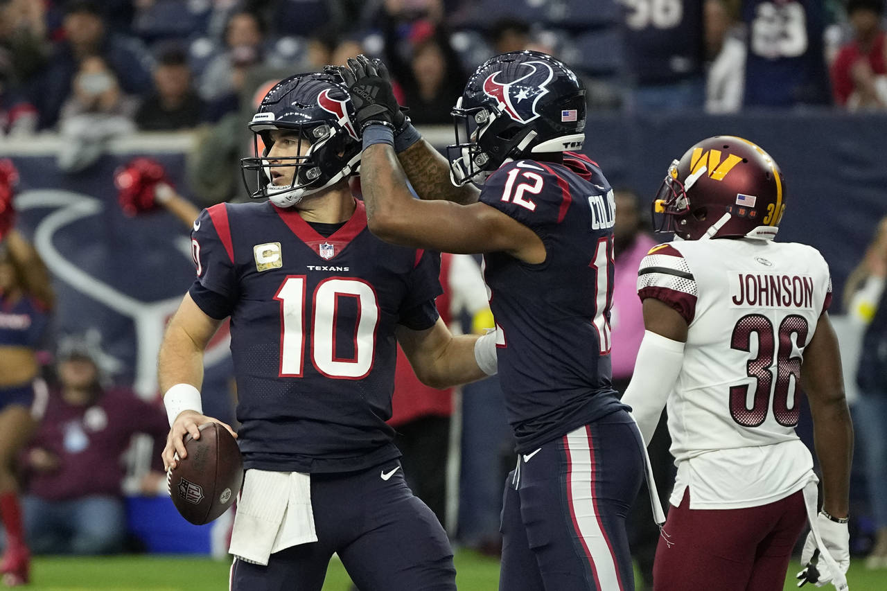 Houston Texans quarterback Davis Mills (10) celebrates his touchdown run with teamamte Nico Collins...