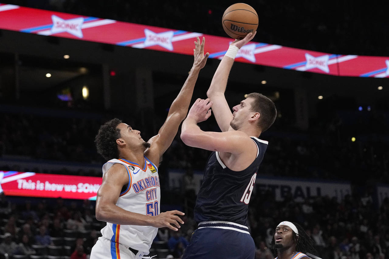 Denver Nuggets center Nikola Jokic (15) shoots over Oklahoma City Thunder forward Jeremiah Robinson...