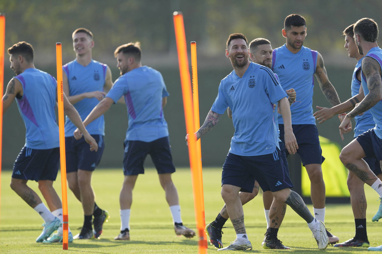 Argentina's Lionel Messi, right, smiles during a training session on the eve of the group C World C...