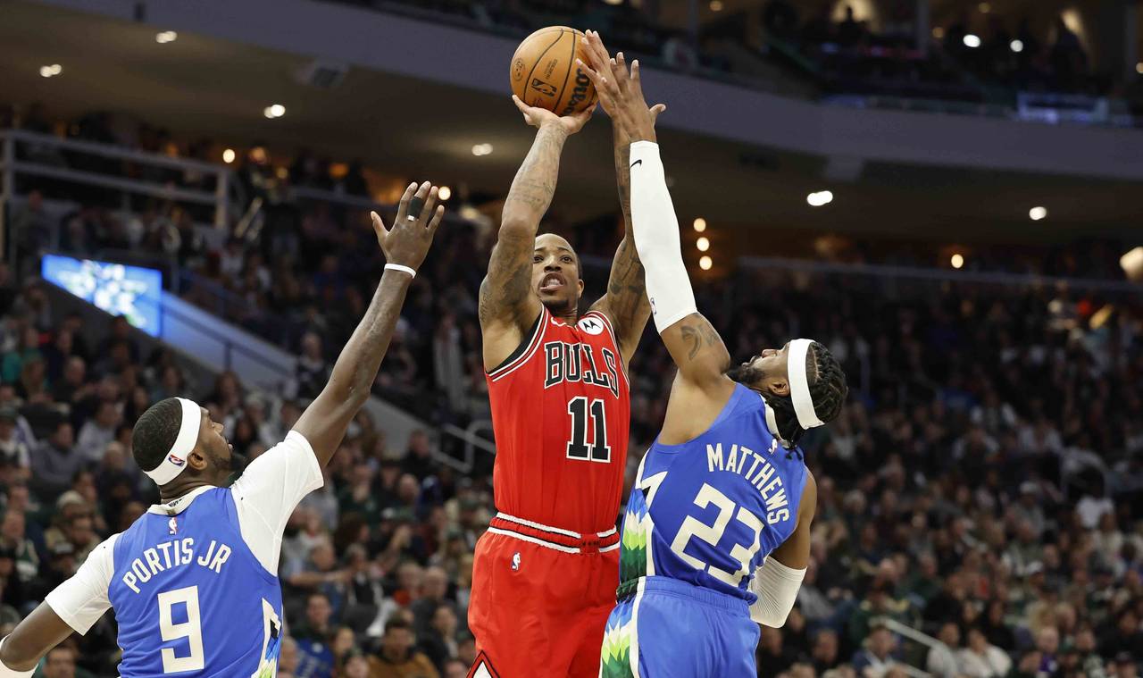 Chicago Bulls forward DeMar DeRozan (11) shoots against Milwaukee Bucks' Wesley Matthews (23) durin...