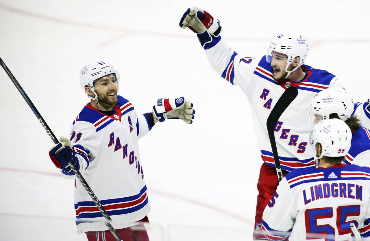 New York Rangers' Barclay Goodrow (21) celebrates his goal with teammates Julien Gauthier (12), Sam...