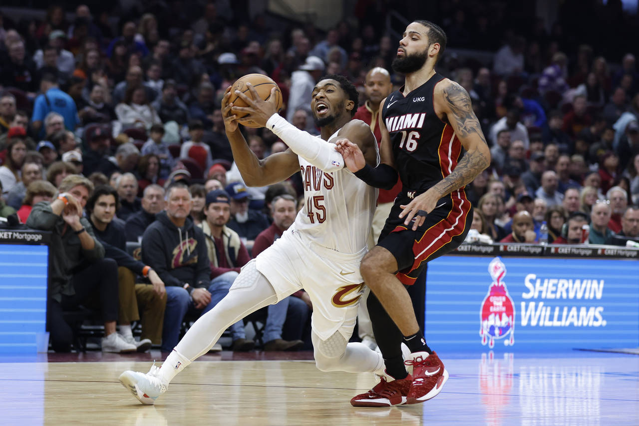 Cleveland Cavaliers guard Donovan Mitchell (45) drives against Miami Heat forward Caleb Martin (16)...