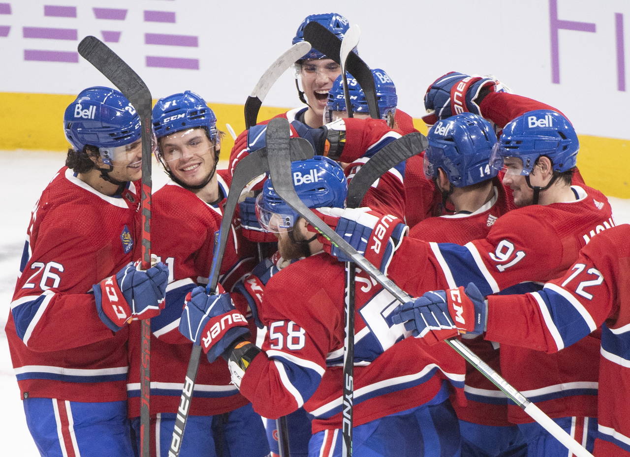 Montreal Canadiens celebrate after defeating the Philadelphia Flyers in an NHL hockey game Saturday...