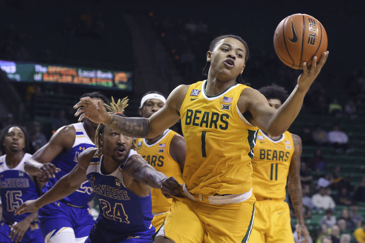 Baylor guard Keyonte George (1) pulls in a loose rebound over McNeese State forward Christian Shuma...