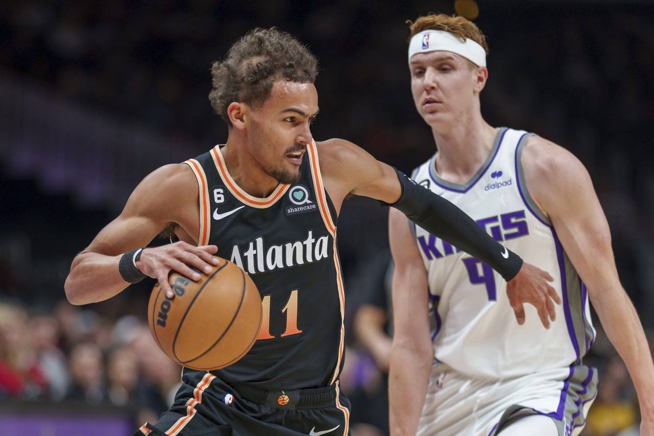 Atlanta Hawks guard Trae Young (11) guards the ball against Sacramento Kings guard Kevin Huerter (9...