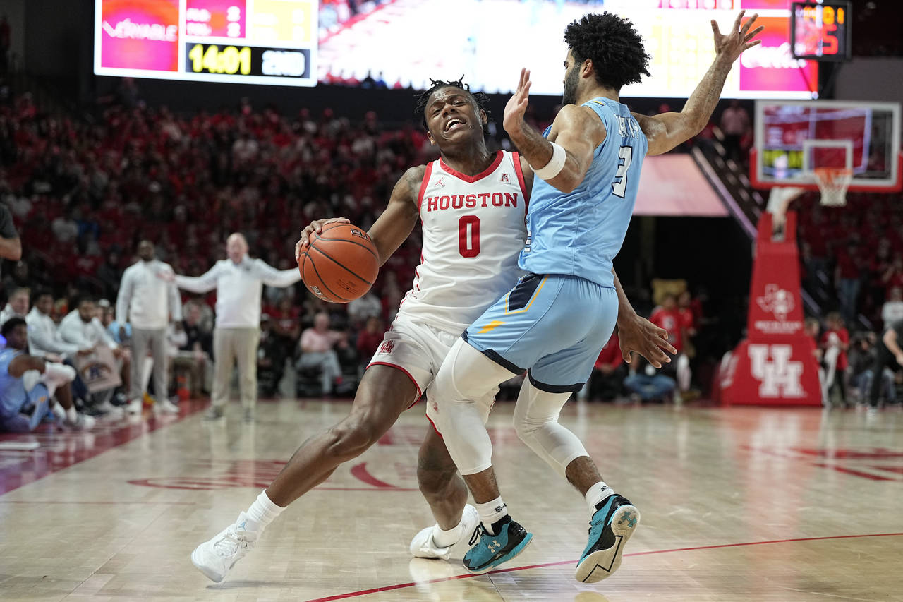 Houston guard Marcus Sasser (0) is defended by Kent State guard Sincere Carry (3) during the second...