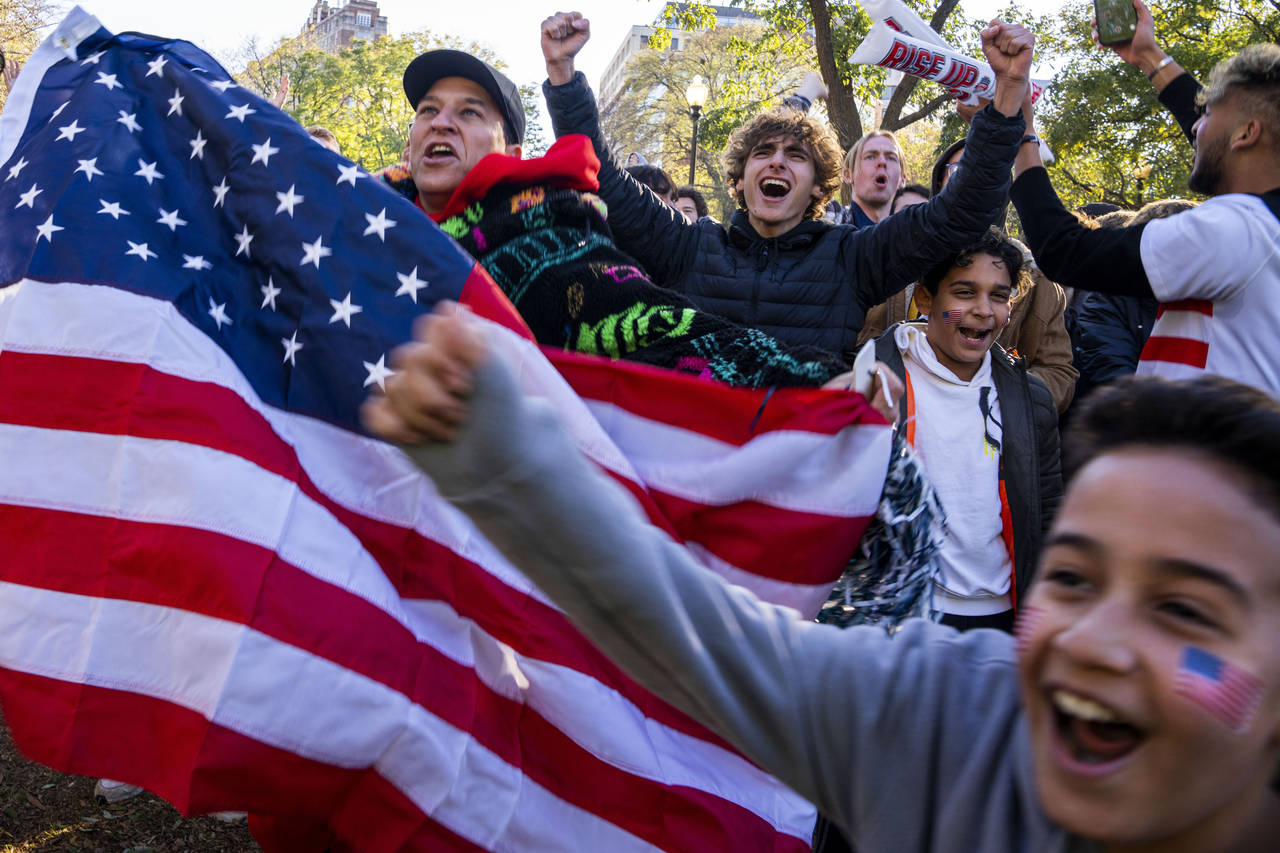 Soccer fans, including Hesham Ibrahim, left, of Vienna, Va., react after the United States scored t...