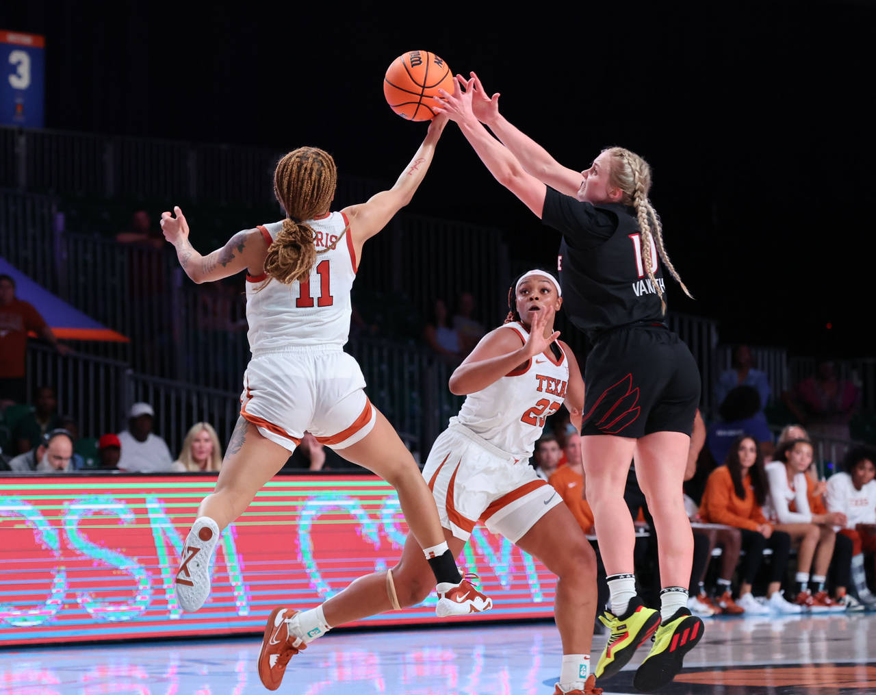 In a photo provided by Bahamas Visual Services, Texas' Sonya Morris (11) goes against Louisville's ...