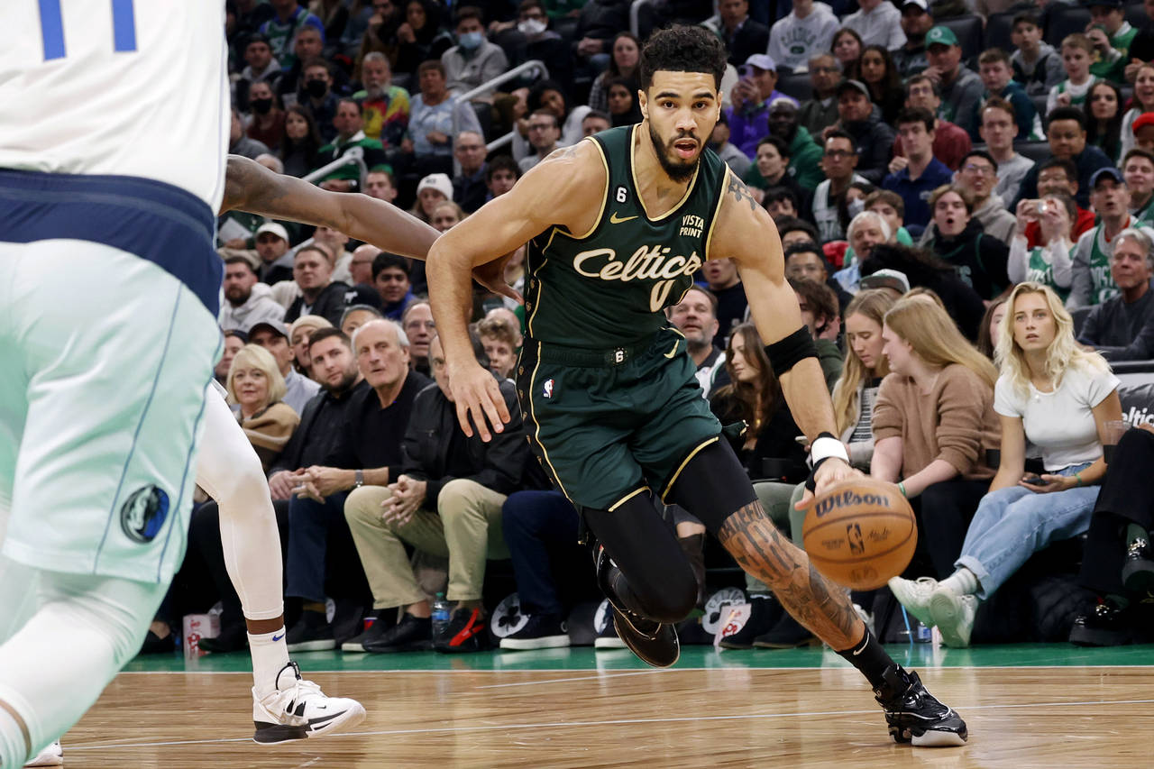 Boston Celtics forward Jayson Tatum (0) drives the basket during the first half of an NBA basketbal...
