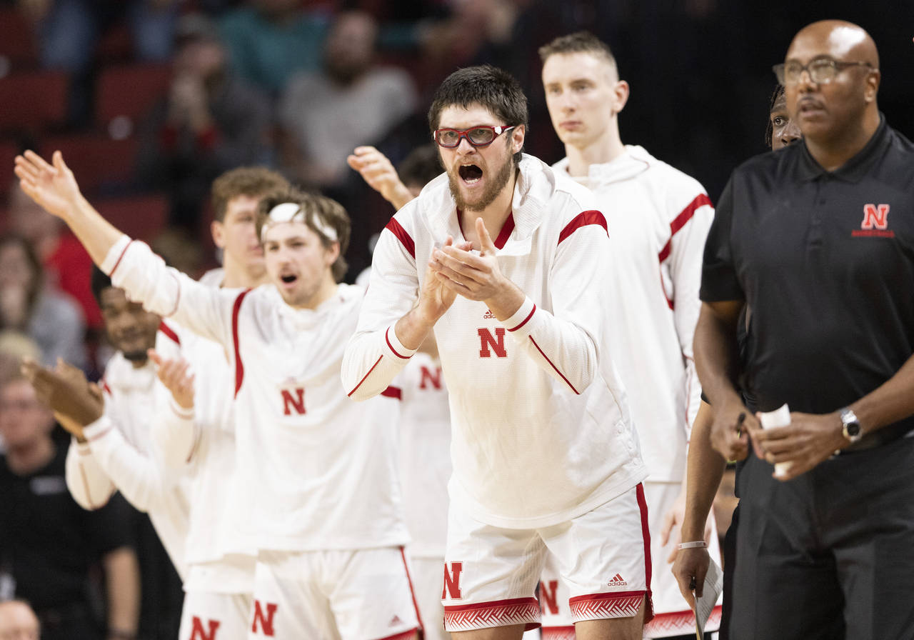 Alongside teammates on the bench, Nebraska's Wilhelm Breidenbach, second from front right, celebrat...