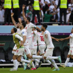 Iran government supporters confront protesters at World Cup