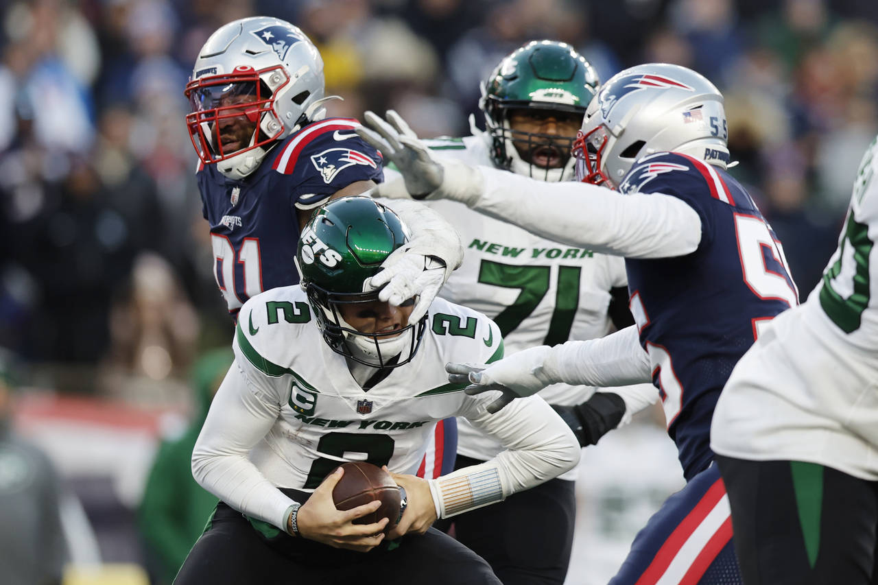 New York Jets quarterback Zach Wilson (2) is sacked by New England Patriots defensive end Deatrich ...
