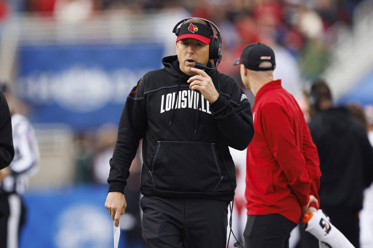 Louisville head coach Scott Satterfield walks down the sideline during the first half of an NCAA co...