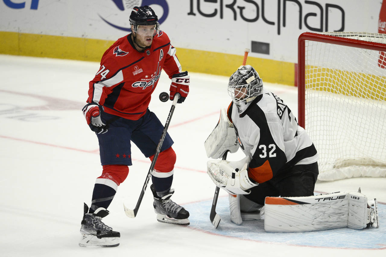 Washington Capitals defenseman John Carlson (74) and Philadelphia Flyers goaltender Felix Sandstrom...