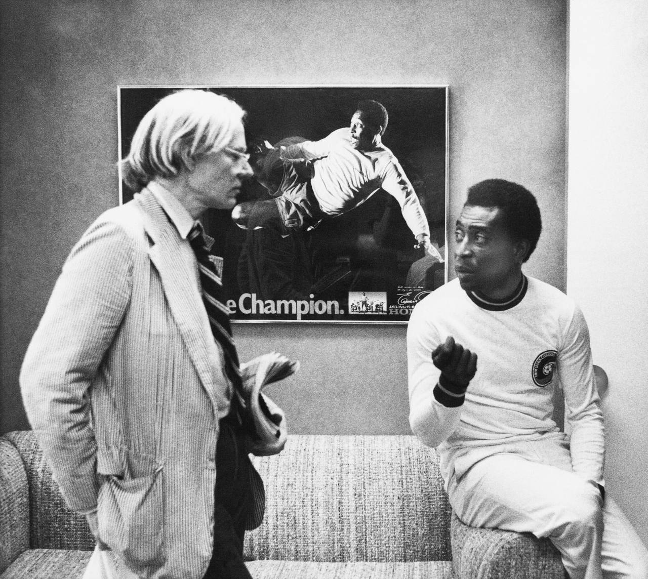 FILE - Artist Andy Warhol, left, chats wth soccer superstar Pele about a portrait he is making of h...