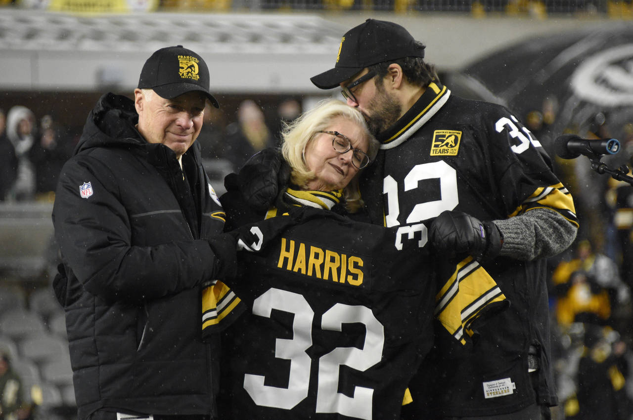 Pittsburgh Steelers owner Art Rooney II, left, and Franco Harris' widow Dana, center, and son Dok, ...