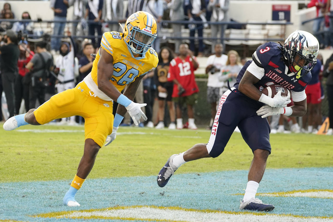 Jackson State wide receiver Kevin Coleman Jr. (3) cradles a 14-yard touchdown pass reception in fro...