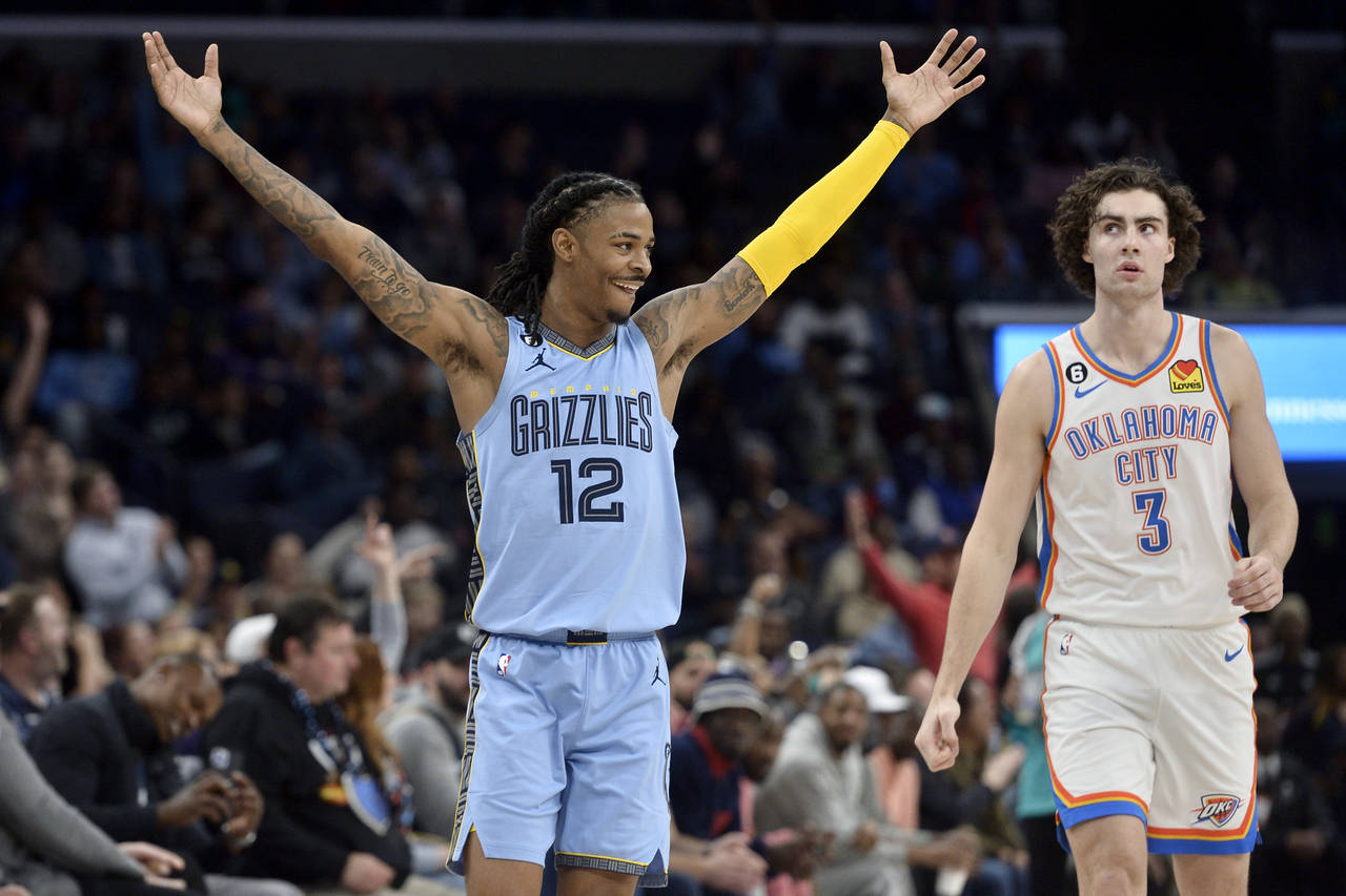 Memphis Grizzlies guard Ja Morant (12) celebrates next to Oklahoma City Thunder guard Josh Giddey (...