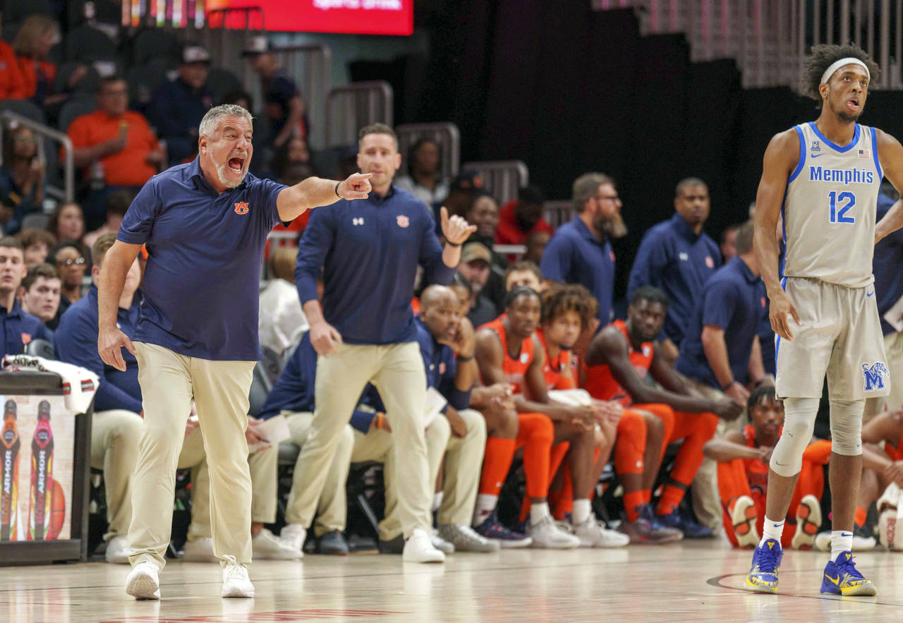 Auburn head coach Bruce Pearl disputes a call during the first half of an NCAA college basketball g...