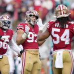 
              San Francisco 49ers defensive end Nick Bosa (97) celebrates after sacking Miami Dolphins quarterback Tua Tagovailoa with teammates Samson Ebukam (56) and Fred Warner (54) during the first half of an NFL football game in Santa Clara, Calif., Sunday, Dec. 4, 2022. (AP Photo/Godofredo A. Vásquez)
            