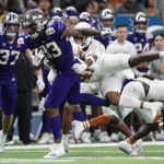 
              Washington tight end Devin Culp (83) is hit by Texas linebacker Jaylan Ford (41) after making a catch for a first down during the second half of the Alamo Bowl NCAA college football game in San Antonio, Thursday, Dec. 29, 2022. (AP Photo/Eric Gay)
            