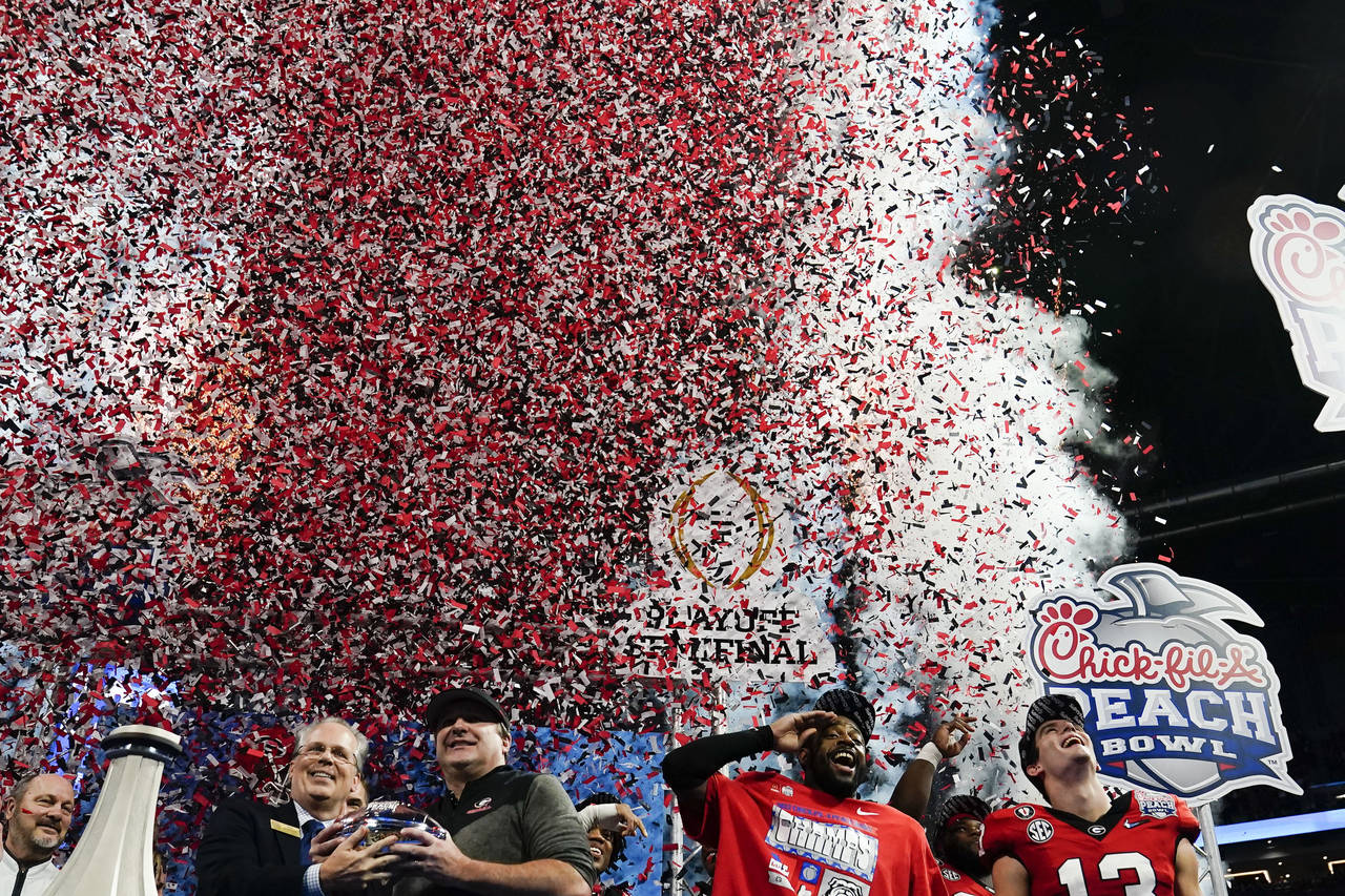 Georgia head coach Kirby Smart holds the The George P. Crumbley Trophy after the Peach Bowl NCAA co...