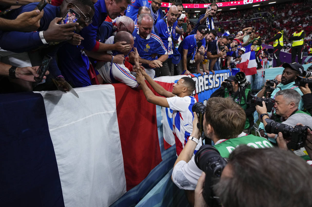 France's Kylian Mbappe greets fans before the World Cup semifinal soccer match between France and M...