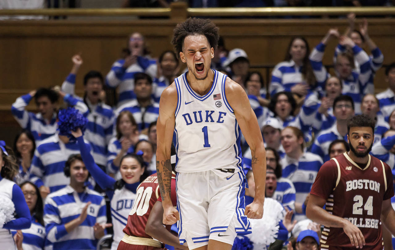 Duke's Dereck Lively II (1) celebrates after a dunk during the first half of an NCAA college basket...