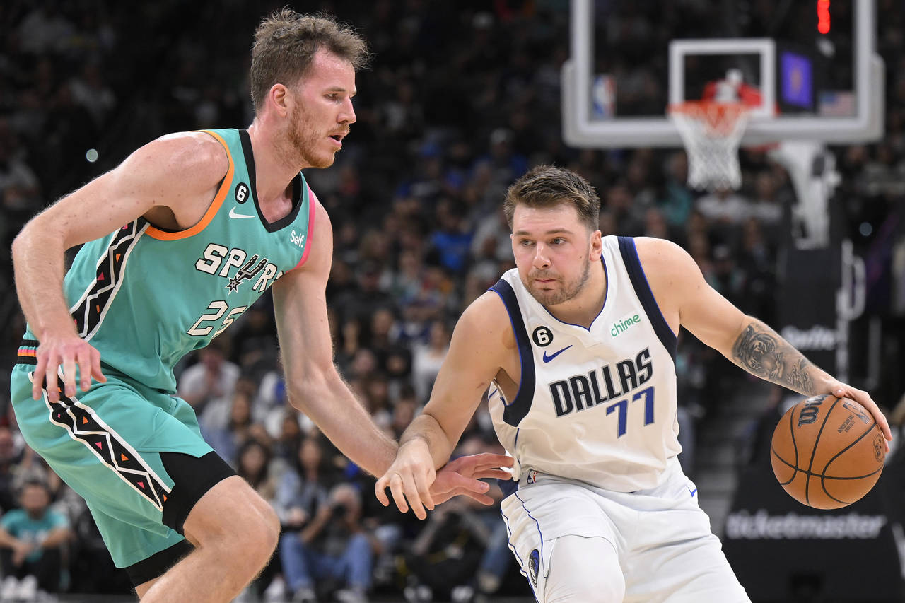 Dallas Mavericks' Luka Doncic (77) drives against San Antonio Spurs' Jakob Poeltl during the first ...