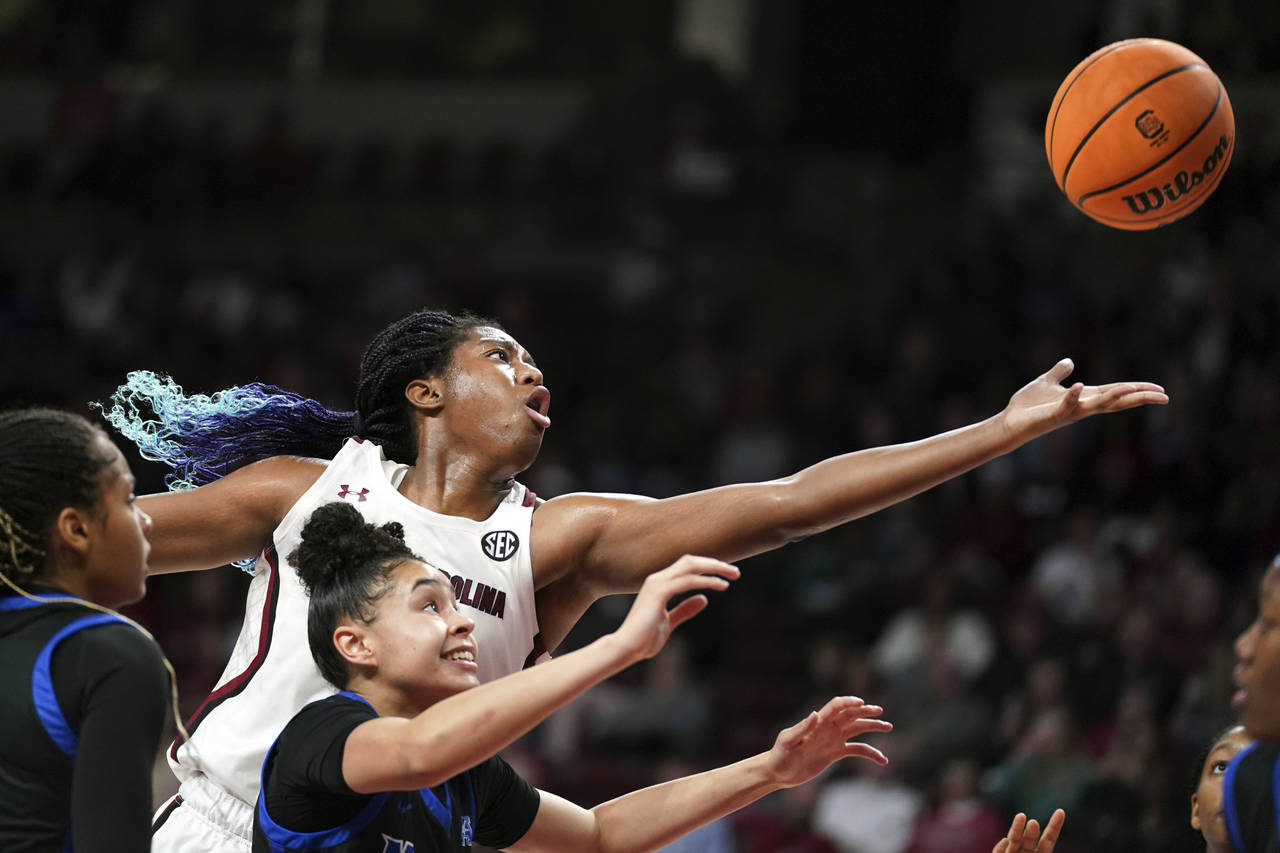 South Carolina forward Aliyah Boston, top, reaches for a rebound against Memphis forward Hannah Rid...